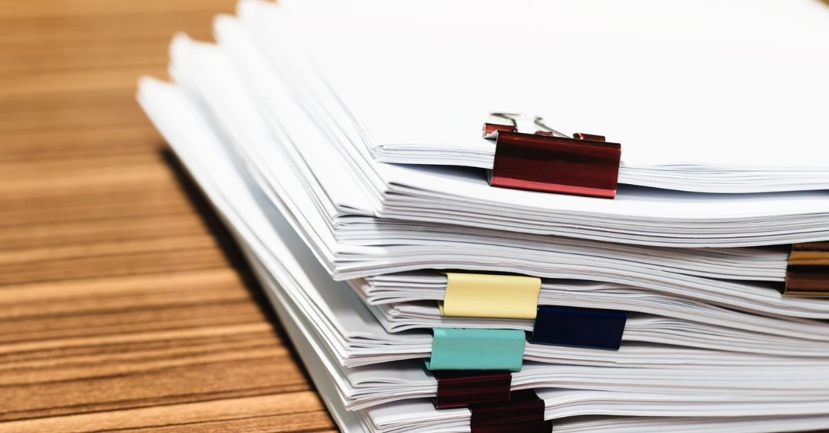 Stacked architectural project submittals and technical material specifications documents.