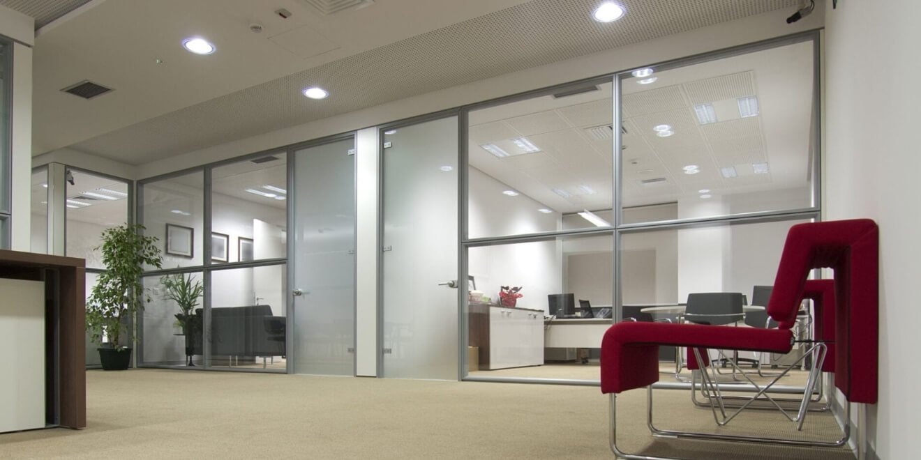 Modern corporate office interior with double glazed acoustic glass partition walls.