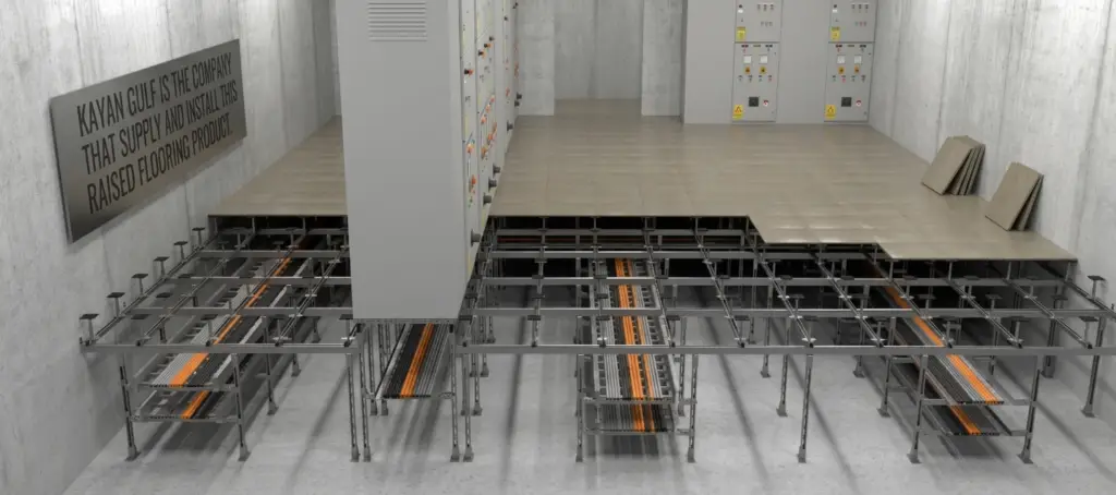 Kayan Gulf industrial raised flooring system installation featuring underfloor steel grid structure, modular cable trays, and electrical server panels.